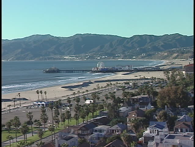 A large community edges a sandy beach.