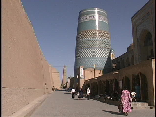 People walk through a short minaret called the Kalta Minor in Khiva, Uzbekistan.