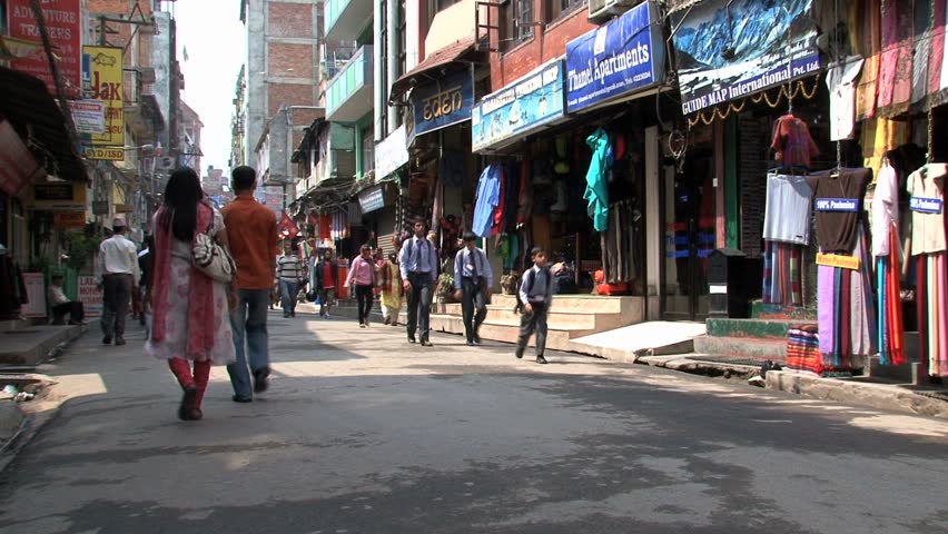 KATHMANDU - CIRCA 2010: People, cars and bikes circulate through the city circa 2010 in Kathmandu.