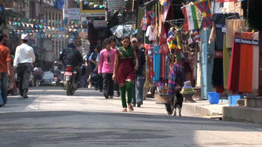KATHMANDU - CIRCA 2010: People, cars and bikes circulate through the city circa 2010 in Kathmandu.
