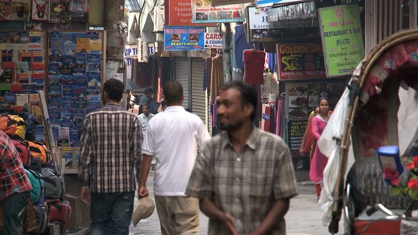 KATHMANDU - CIRCA 2010: People, cars and bikes circulate through the city circa 2010 in Kathmandu.