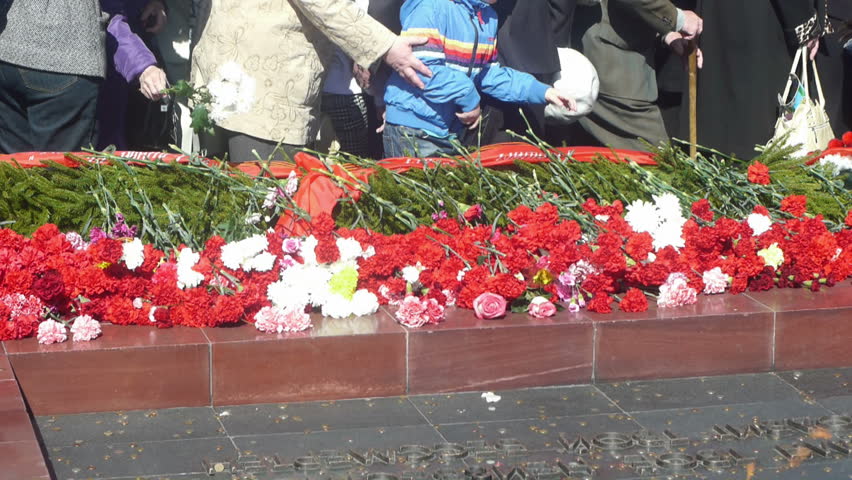 Laying down flowers to Unknown Soldier of World War II at  Eternal Flame monument