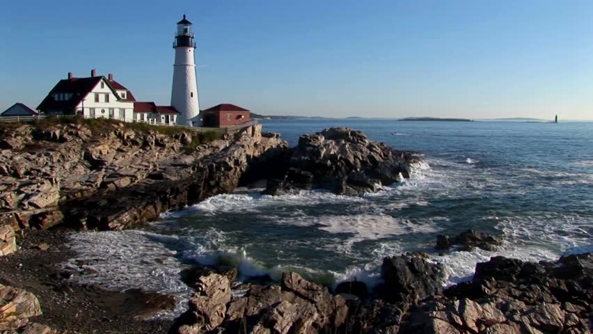 The Portland Head Lighthouse oversees the ocean from rocks in Maine, New England. 