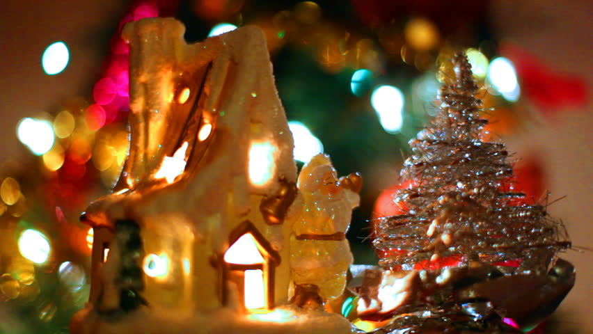 fabulous toy house with Santa Claus and small Christmas tree, around colorful garlands