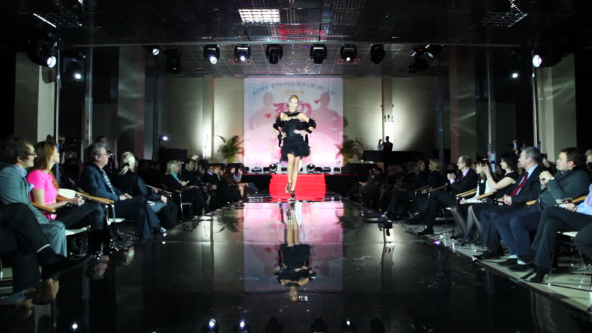 MOSCOW - FEBRUARY 14: Model in black short dress with cape on her shoulders walks catwalk at Evening of French fashion in salon Estet, on February 14, 2011 in Moscow, Russia. 