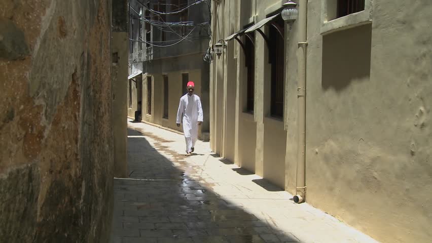 STONE TOWN, ZANZIBAR - CIRCA 2009: A Muslim man walks in the narrow alleys of Stone Town, Zanzibar.