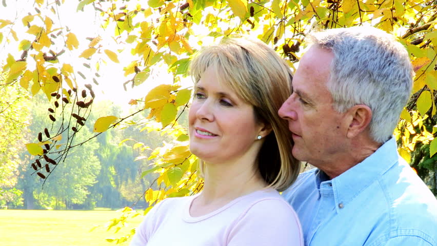 Happy elderly senior couple in park 