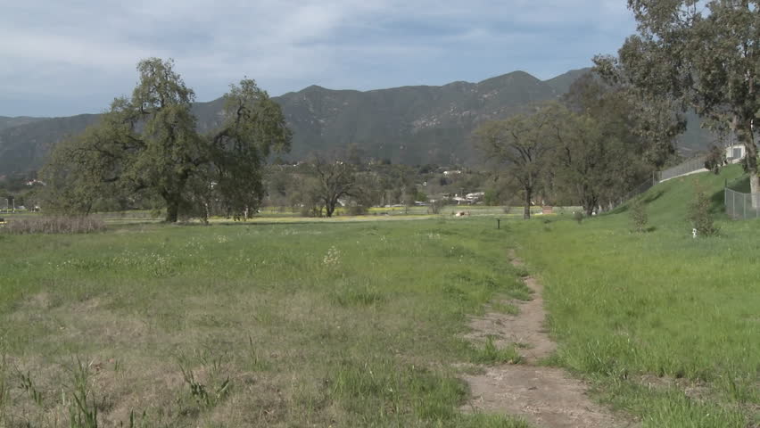 OJAI, CA - CIRCA 2009: A woman and girl walking through a restored wetlands at the Ojai Meadow Preserve circa 2009 in Ojai, California. Besides the ecological value of the restored wetlands, they act as a sponge to soak up storm runoff and prevent floodin