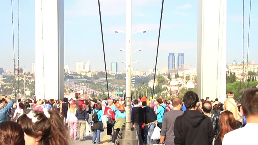 ISTANBUL - OCTOBER 17: Crowd of people walk from Asia to Europe on Bosporus Bridge on October 17, 2010 in Istanbul.