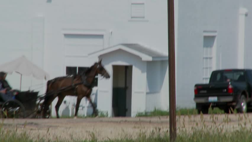 PENNSYLVANIA, PA - CIRCA 2009: An Amish horse and buggy moves amongst modern traffic circa 2009 in Pennsylvania.