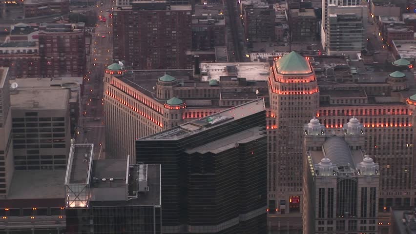 An aerial view of Chicago's Merchandise Mart includes its green roof-towers and exterior lights
