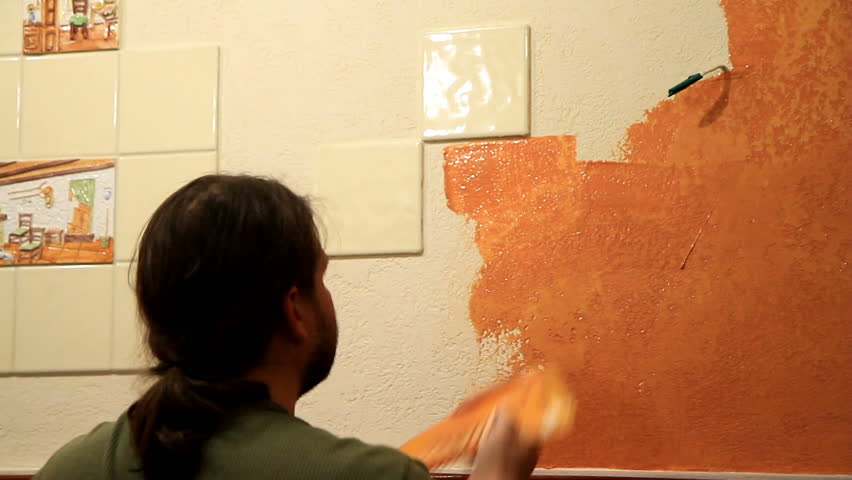 Master applies colored wax on ornamental plaster. 