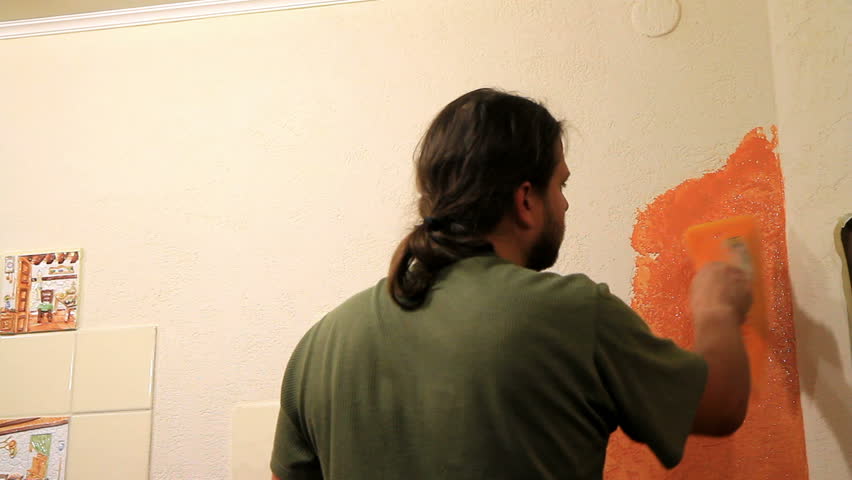 Master applies colored wax on ornamental plaster. 