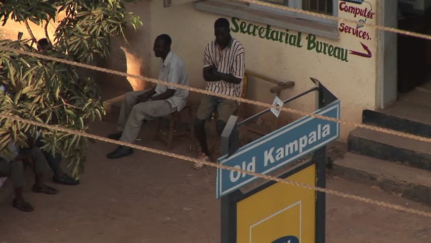 KAMPALA, UGANDA - CIRCA 2009: Several men sit outside the Secretarial Bureau circa 2009 in Kampala.