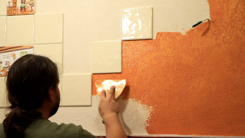 Master applies colored wax on ornamental plaster. 