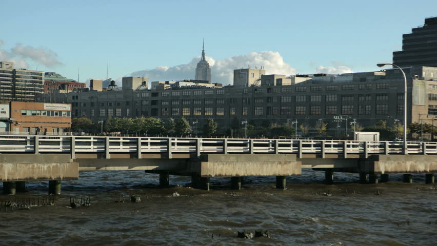 New York City time-lapse showing cloud movement and the Empire State Building in the far background, taken from a pier on the Hudson river