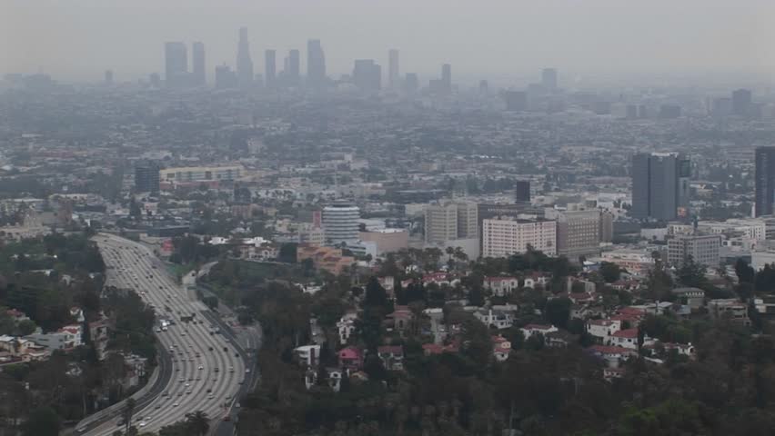 Smog hangs on the distant cityscape