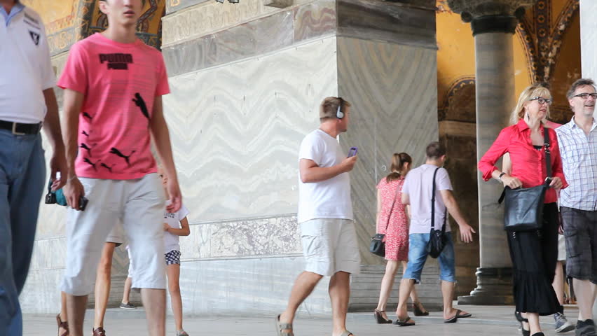 ISTANBUL TURKEY - JULY 31: Tourists walk through Hagia Sophia on July 31, 2011 in Istanbul. The Hagia Sophia was the largest cathedral in the world for nearly a thousand years, until Seville Cathedral was completed in 1520.