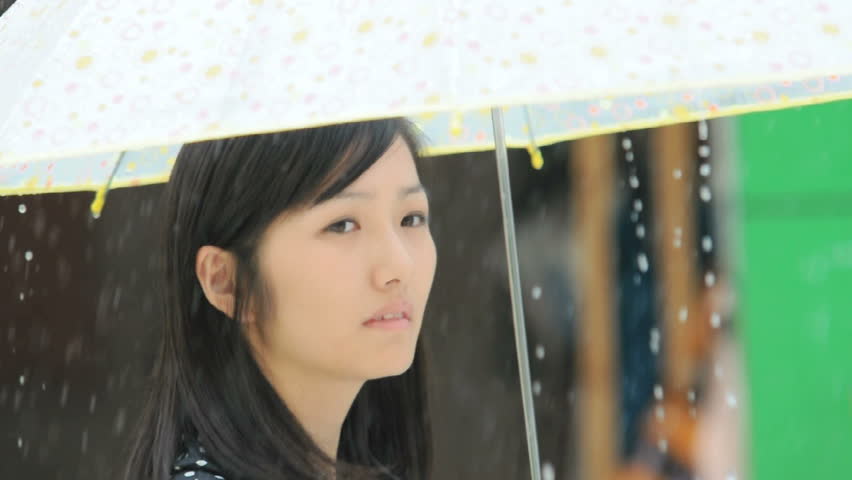 Asian girl with umbrella in the rain.