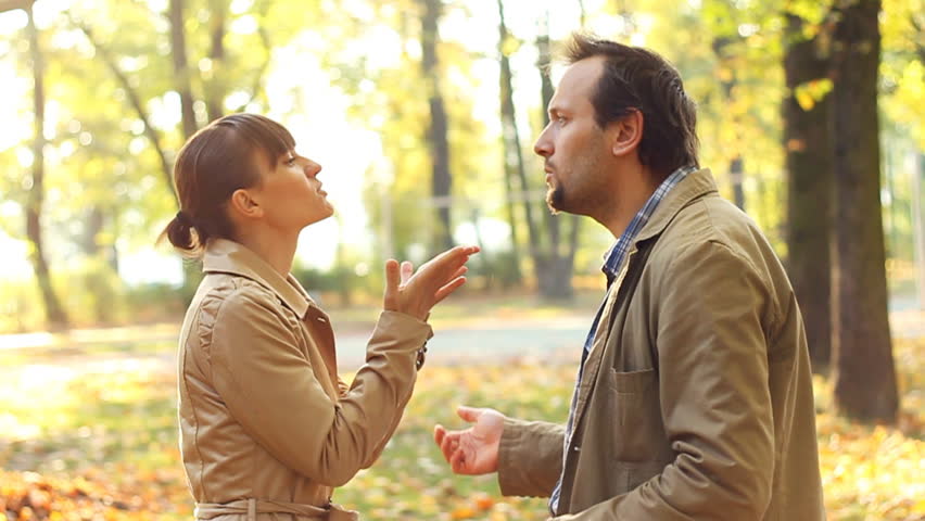 Young couple having fight in autumn park, slow motion