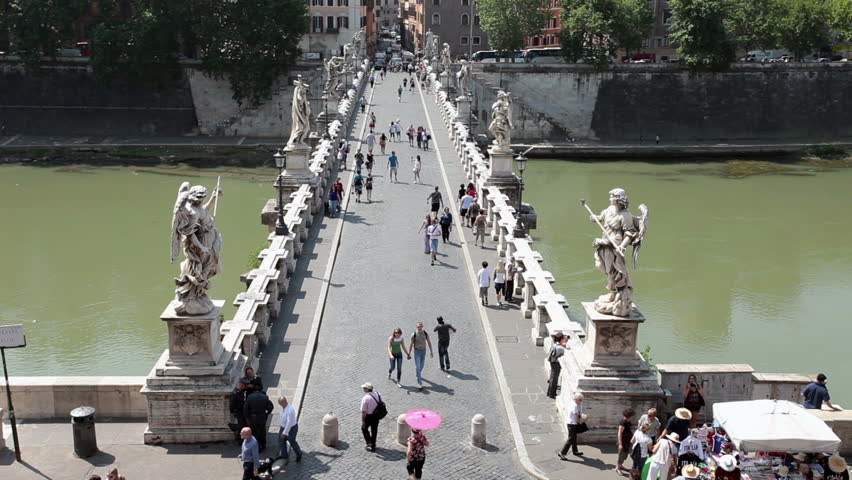 Tourists crossing famous Bridge of Angels Castel Sant Angelo in Rome. May 25, 2011. Tomb of the Roman emperor Hadrian, called Hadrian's mole. Bridge over the Tiber River. 