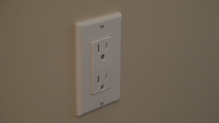 Plugging a power plug into a wall outlet