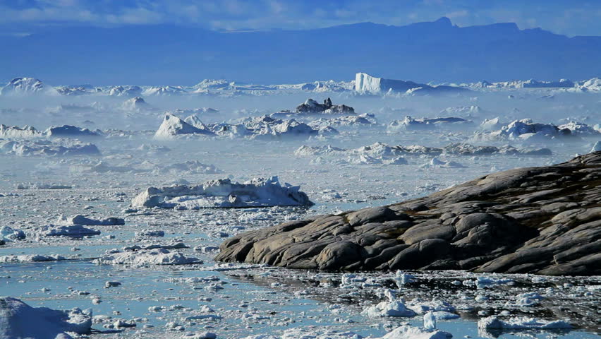 Melting Ice Floes Moving Between Icebergs
