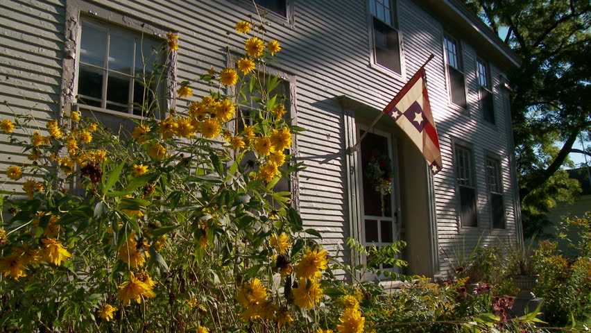 Flowers and flag outside white household