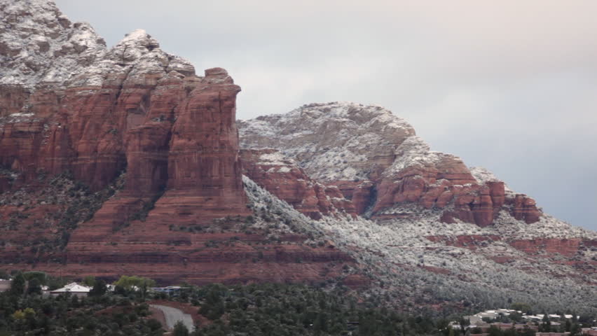 Heavy, early-morning clouds cover the grandeur of Sedona, Arizona with a light dusting of snow.