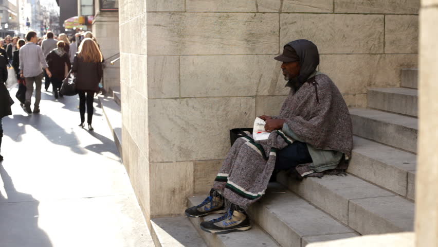 NEW YORK CITY, NY - NOVEMBER 25: Homeless man sitting on steps asking for money during Black Friday shopping spree on November 25, 2011 in New York City, New York. 