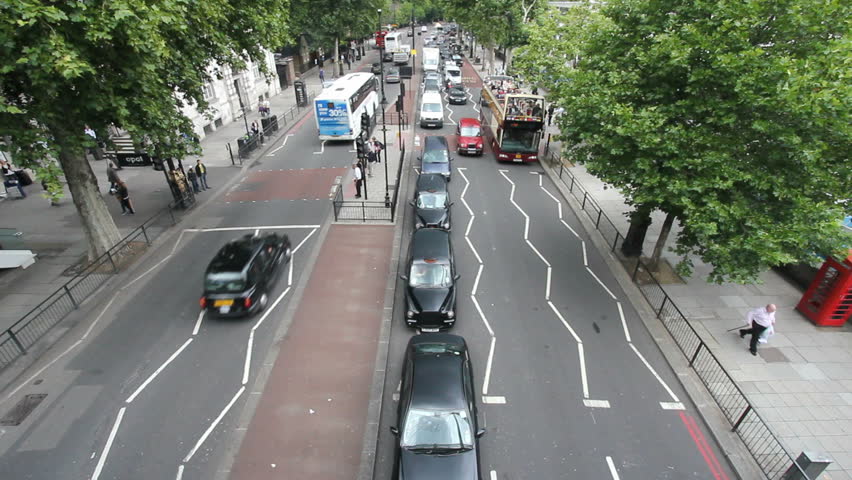 LONDON, UK - JULY 25: Big Bus tourist coach and other traffic on Victoria Embankment on July 25, 2011 in London, UK. Victoria Embankment runs along the Thames from Westminster to Blackfriars Bridge.