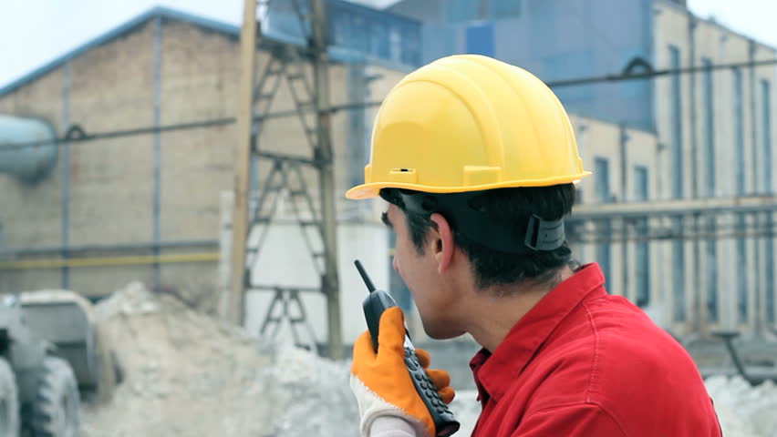 Construction worker and wheel loader on the construction site. HD 1080i. 