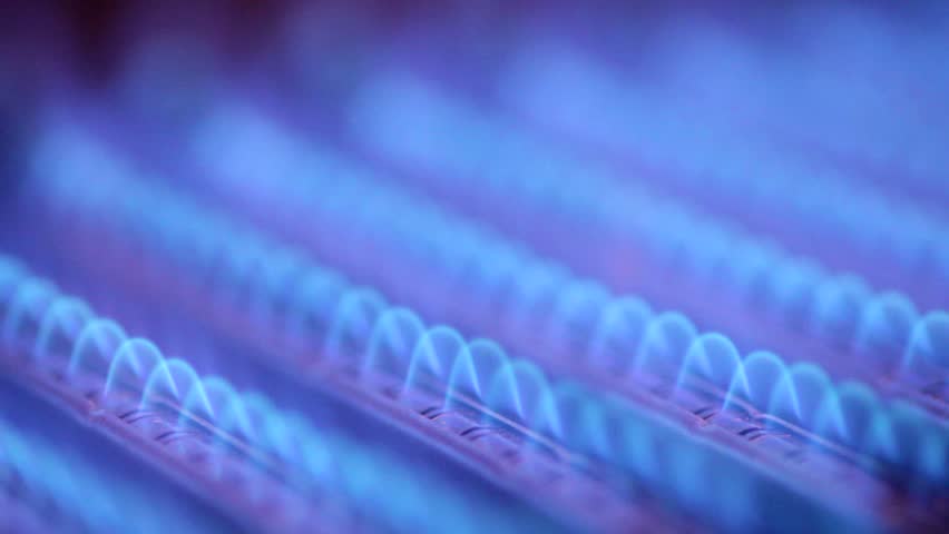 Blue flames of a gas burner inside of a boiler