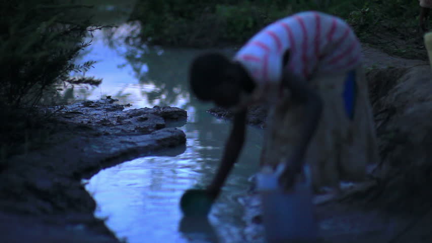 KENYA, AFRICA - CIRCA AUGUST 2010: Child gathering water near a village in Kenya two hours of north of the Africa city Mombassa in August 2010.