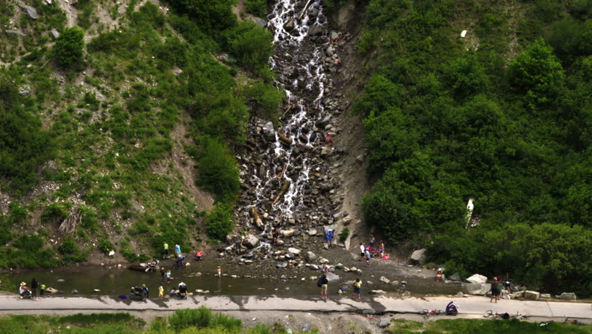 People standing at the bottom of Bridal Veil Falls in Utah.
