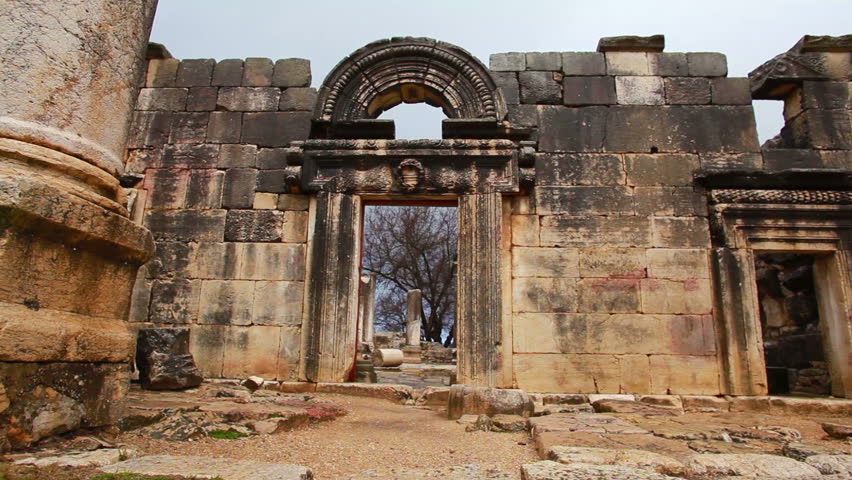 Medium wide dolly right to left of the entrance facade of the ruins of one of the oldest synagogues in Israel, located at Bar'am National Park, Israel.  