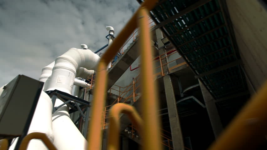 Low angled slider dolly shot looking up at the stairway and huge white pipes at the IDE Ashkelon Desalination plant in Israel.