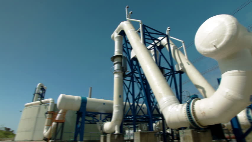 Wide pan, left to right, along jungle gym of huge white desalination pipes at the IDE Ashkelon desalination plant in Israel.