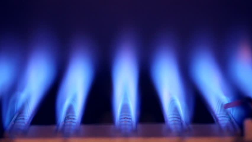Blue flames of a gas burner inside of a boiler