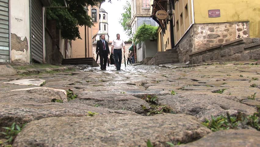 PLOVDIV, BULGARIA - CIRCA MAY 2007: People walk the cobblestone street circa May 2007 in downtown Plovdiv.