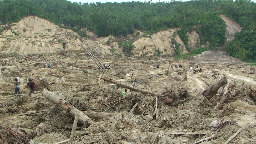 PADANG, INDONESIA - CIRCA OCTOBER 2009: Survivors stand on remains of village wiped out by earthquake induced landslide in Padang, Indonesia circa October 2009.