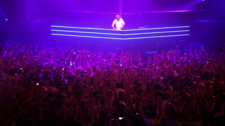 MOSCOW - MAY 6: Popular Dutch DJ Armin Van Buuren on stage with pink blue light, many people, on May 6, 2011 in Moscow, Russia.