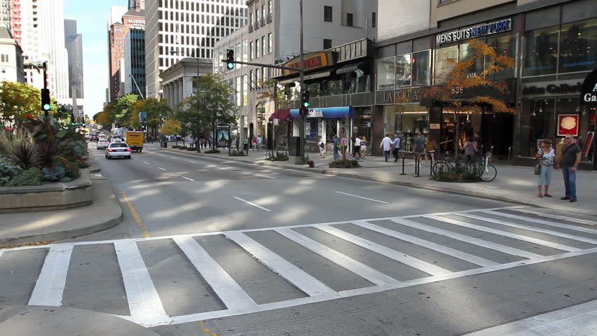 CHICAGO - CIRCA SEPTEMBER 2011 - Time lapse, Cars and pedestrians crossing the street at a crosswalk intersection on Michigan Avenue