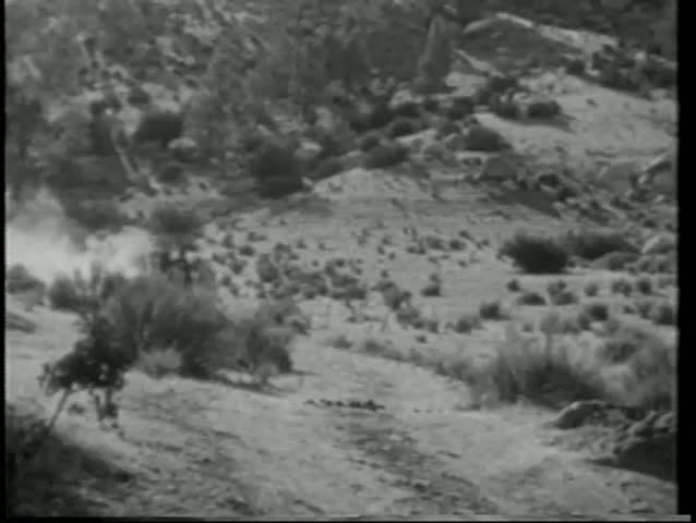 Wide shot cowboys on horseback on a wild chase