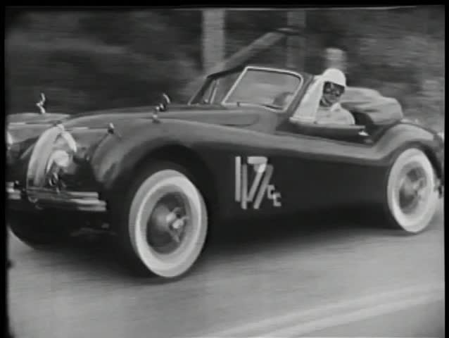 Two sports cars attempting to overtake each other during race