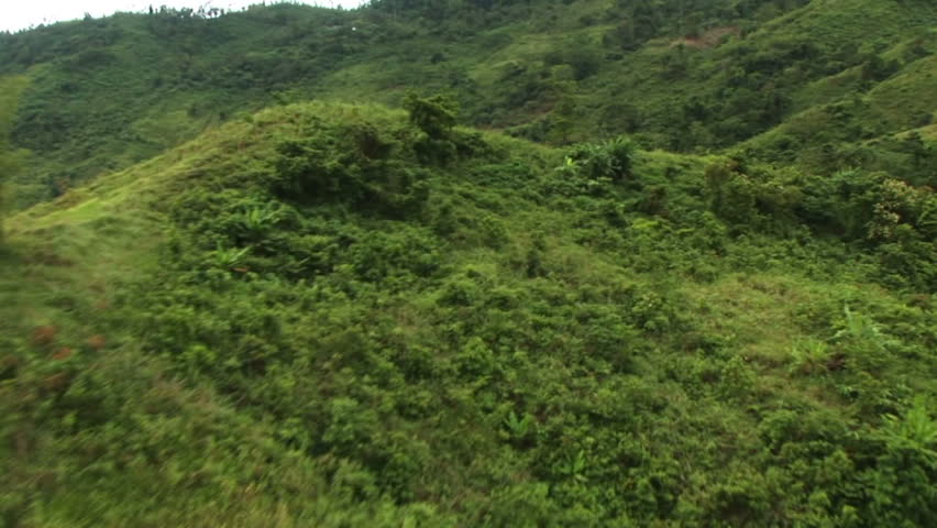 HD: Helicopter circles natives hiking over mountain #3