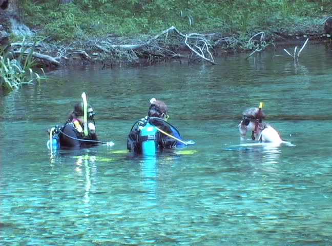 A woman and her daughters prepare to dive the spring cavern at Ginnie Springs, High Springs, Florida.