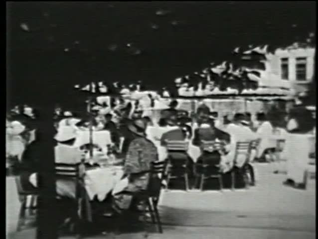 People eating in outdoor cafe, New York City,  1930s