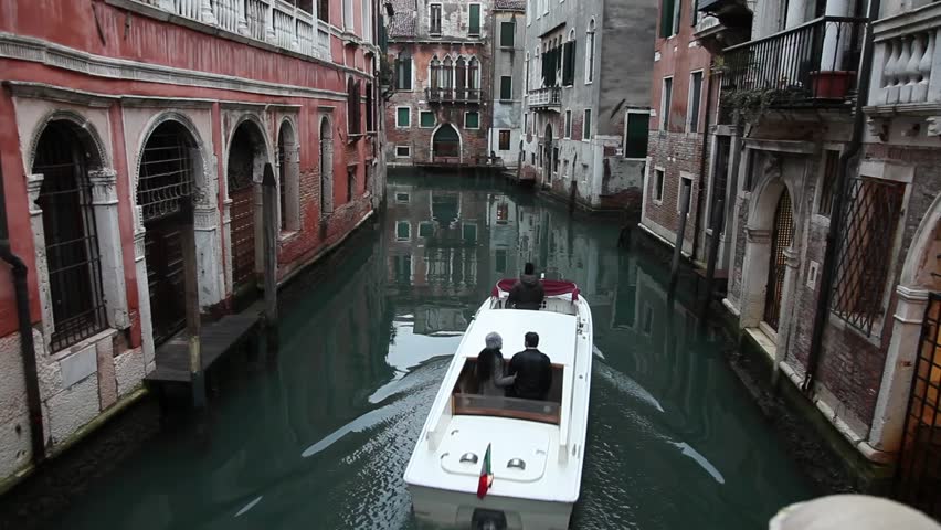 Boat passage along a canal in Venice, Italy