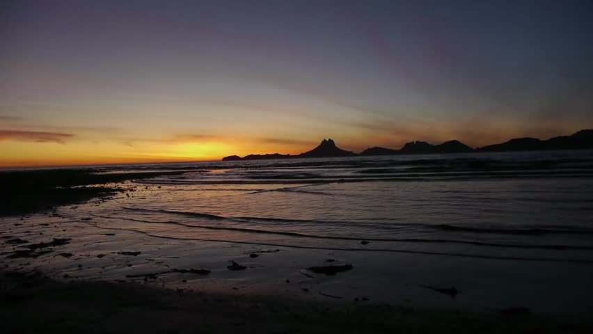 Waves seep into the sand during a beautiful sunset